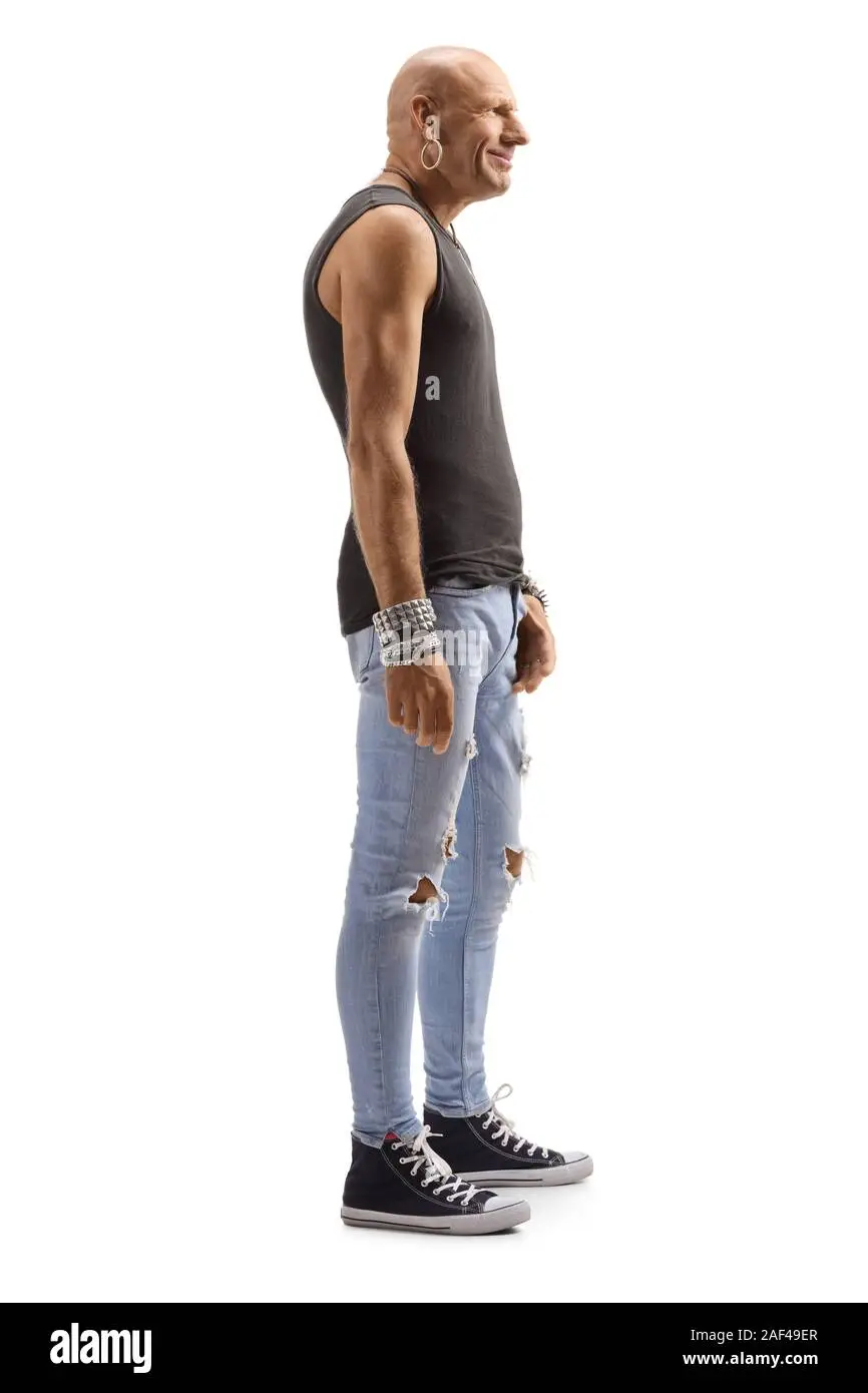 full-length-profile-shot-of-a-bald-male-hipster-wearing-ripped-jeans-and-black-sleeveless-top...webp