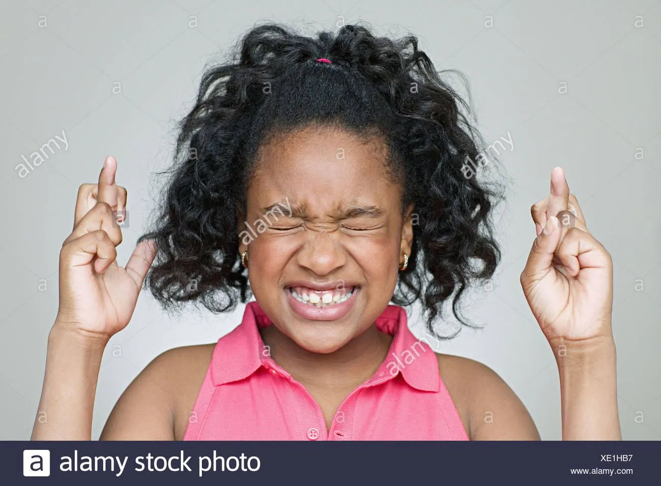 girl-with-fingers-crossed-XE1HB7.webp