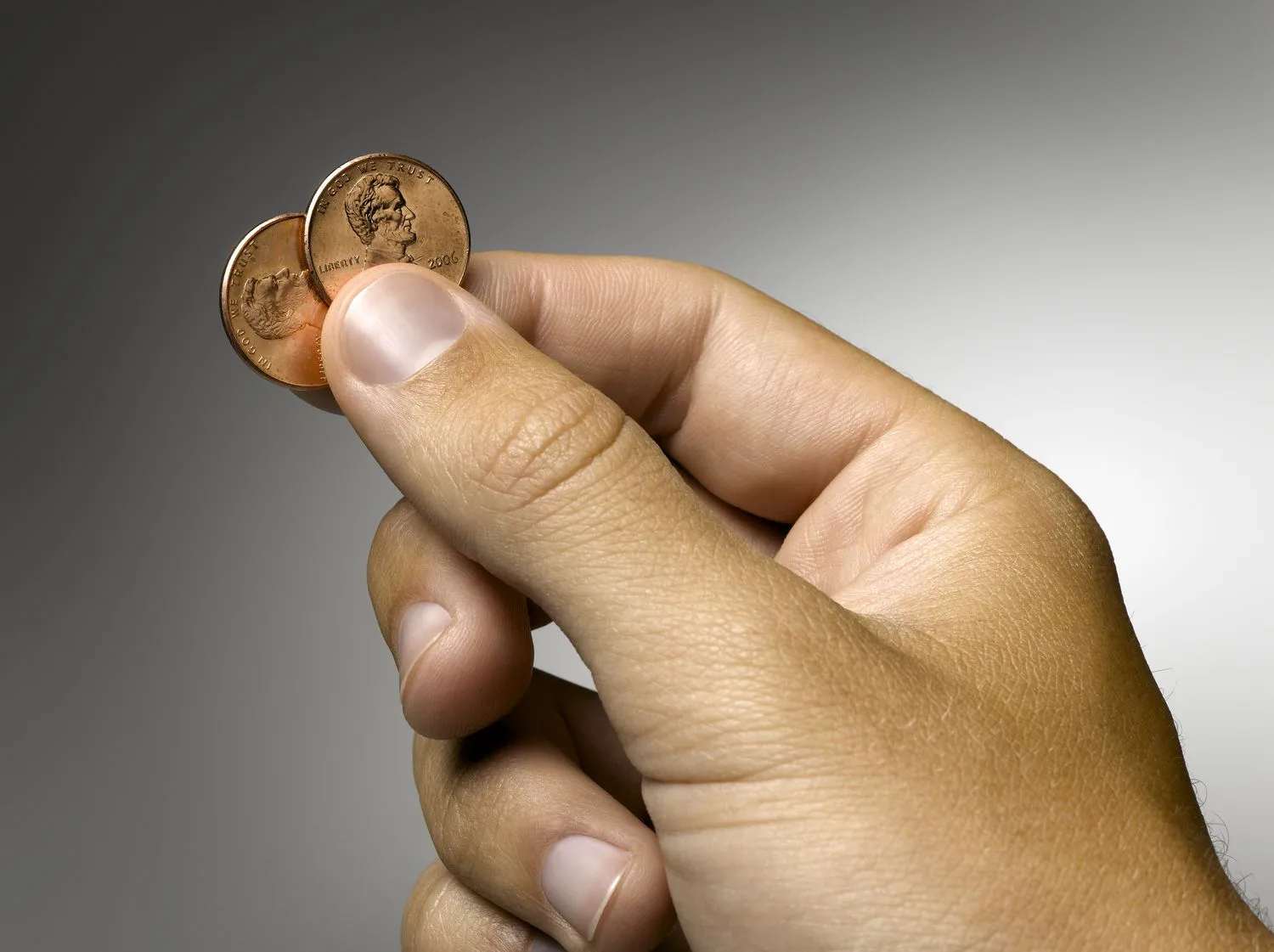 man-holding-two-pennies--focus-on-hand--200565742-001-5aecf759875db9003747c681.webp