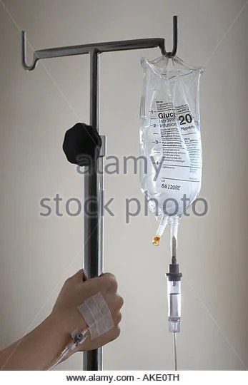 persons-hand-holding-stand-with-drip-bag-ake0th.webp