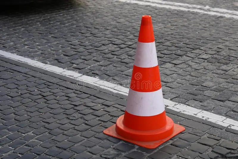 traffic-cone-road-cobble-stone-149363975.webp